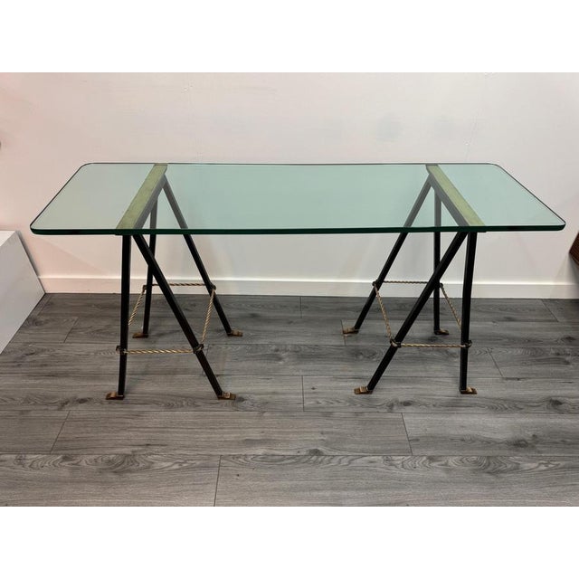 An exceptional iron & 15mm thick glass trestle console table with twisted brass rope detailing to the base & plates to the...