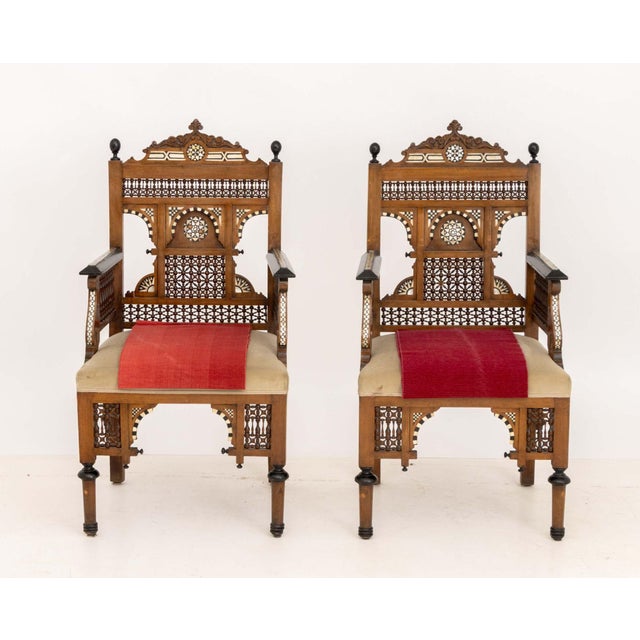 Pair of Moroccan Inlaid Walnut Armchairs, with bone and mother of pearl inlay, beige velvet seats on turned wood legs. 42"...