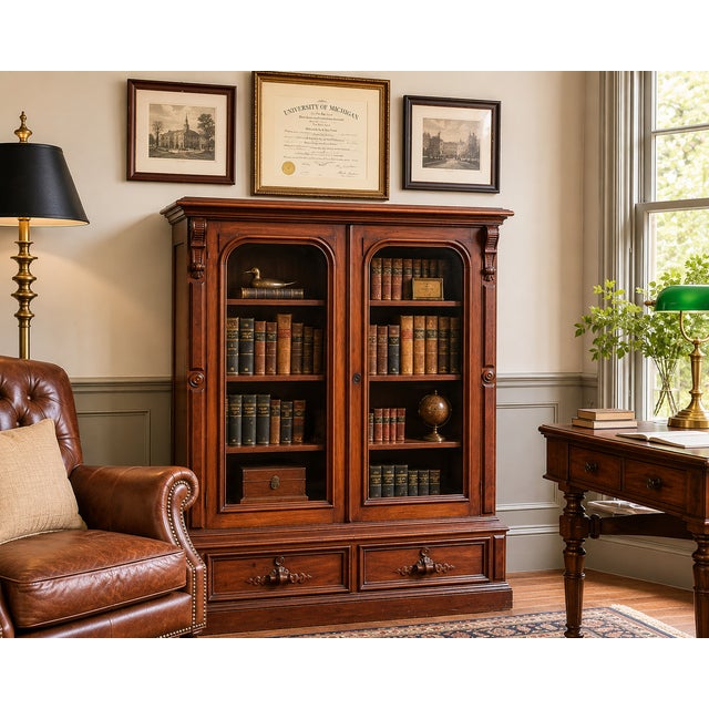 A handsome late 19th-century walnut bookcase dating to the Victorian period, featuring a pair of arched glazed doors above...