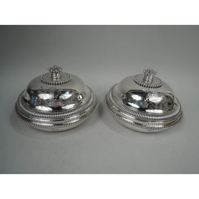 Pair of George III sterling silver covered vegetable dishes. Made by Paul Storr in London in 1805. Each: Tapering bowl...