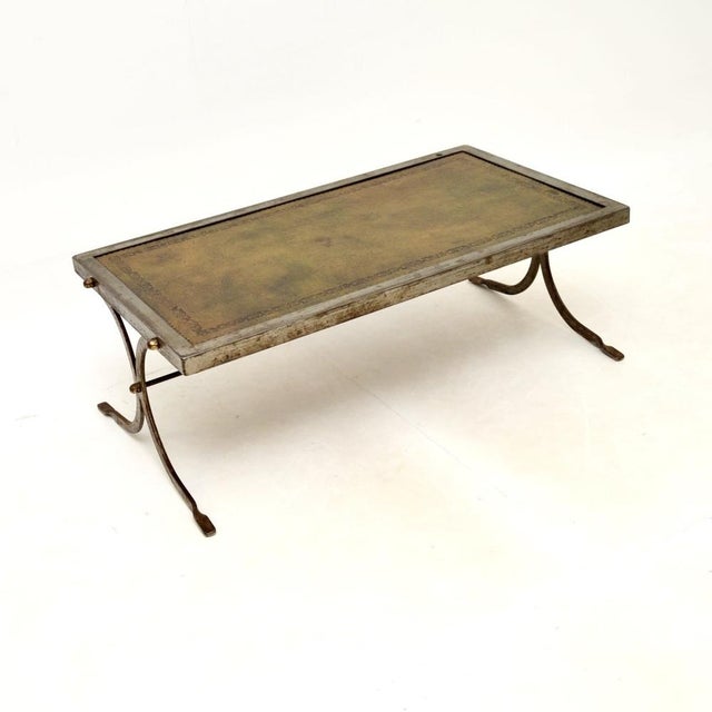 A smart and unusual vintage French steel and leather coffee table, dating from the 1960’s. This has a great design, the...