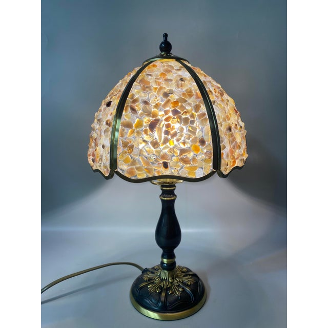 The lampshade is made of yellow-green colored stone mosaic, paired with a black-gold two-tone metal lamp body (with carved...