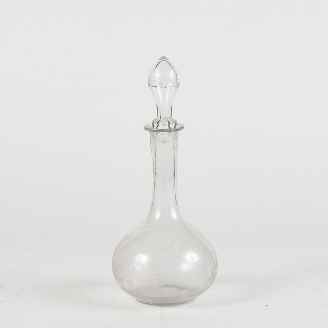 Glass bottle cruet with engraved floral decoration 20th century measures 14 x h 34 the bottle probably used to serve...