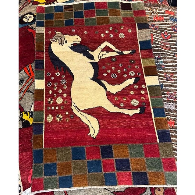 A charming and highly collectible vintage Azeri Gabbeh rug, handwoven approximately 70 years ago. This small-scale piece...