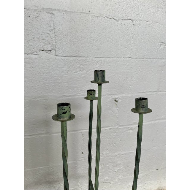 Postmodern floor candleabra with interesting twists and curves. Tall and sleek four candle holder. Painted wrought iron...
