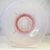 Fenton Art Glass’s 1987–88 “Sheffield” bowl pairs a clear base with a soft pink opalescent overlay. The ribbed, sunburst...