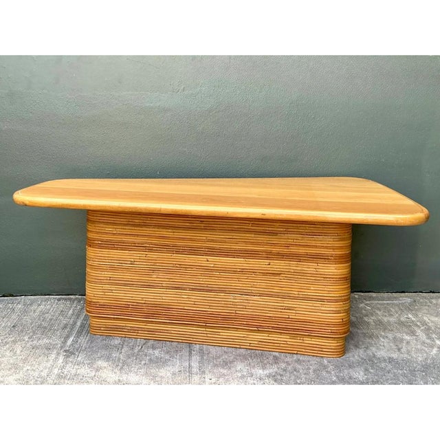 This vintage desk is a bold, sculptural piece, pairing a smooth wooden surfboard top with a solid pedestal wrapped in...