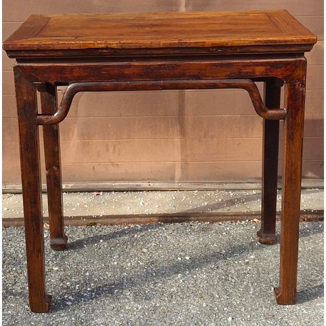 A 19th Century Chinese Ming Style Qing Elm Wood Parlor Table. Measures 34.5" in width, 21.5" in depth and stands 33.5" tall.