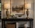 A refined pair of vintage urn-form table lamps finished in warm antique brass, distinguished by a pierced metal frieze...