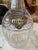 Antique hand carved crystal English decanter with a sterling silver Brandy tag. The decanter has an etched initial or...