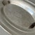 Elegant vintage silver-plated oval serving platter featuring an ornate engraved floral and scrollwork medallion at the...