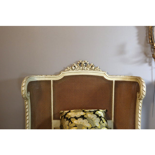 Pair of Louis XVI style beds in painted wood and canework. These beds are decorated with sculptures with floral...