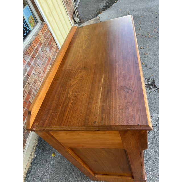 Interesting antique walnut cupboard or sideboard. Two drawers over two cabinet doors with a shelf within. Handcut...