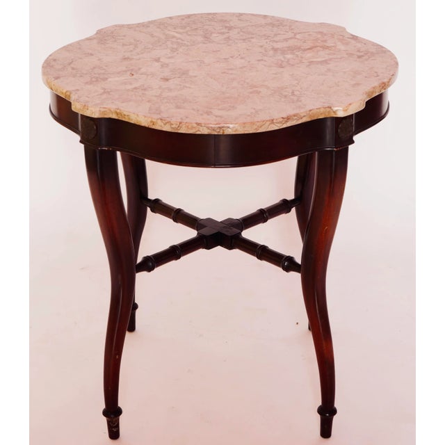 Ornately carved mahogany centre table with rouge marble top. A beautiful table will look great paired with a pair of...