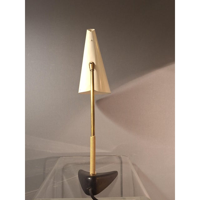 Table lamp, model Style number 1213, by J. T. Kalmar, Vienna. Black cast iron base, brass arm, lacquered lampshade....