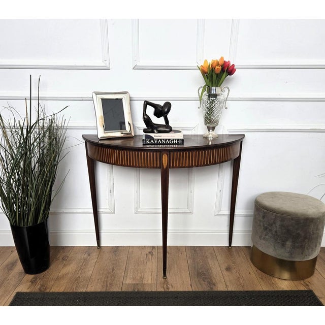 Very elegant and refined Italian Mid-Century Modern design demi lune console side table. Standing on four typically shaped...
