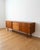 Danish teak sideboard from the 1960s, 209 cm. The frame features two sliding doors—one on each side—with vertical handles,...