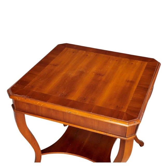 A pair of Alfonso Marina side tables featuring a square top with distinctive notched corners above a practical lower tier....