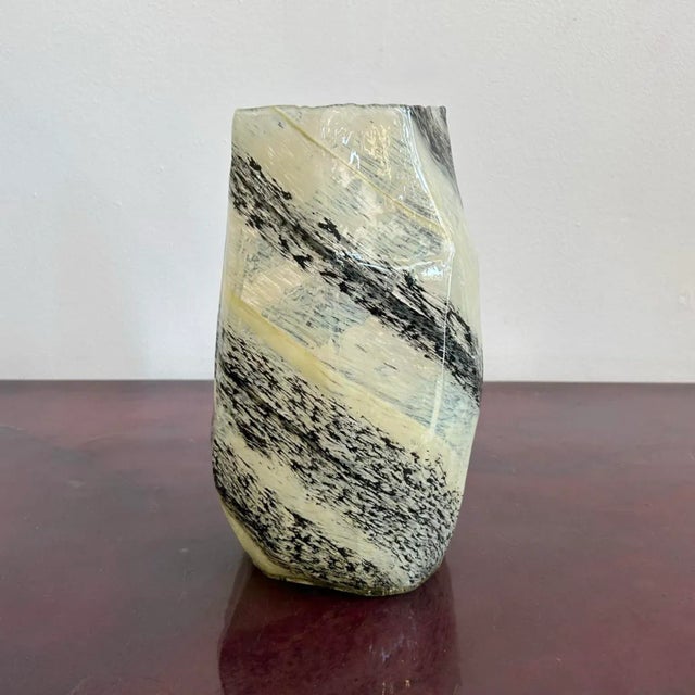 This contemporary glass vase features an angular, asymmetrical form wrapped in bold, gestural black strokes across a...