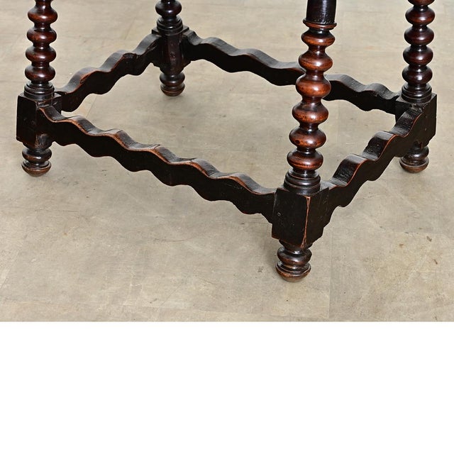 A Spanish Baroque solid chestnut table from the 18th century, showcasing the bold craftsmanship characteristic of the...