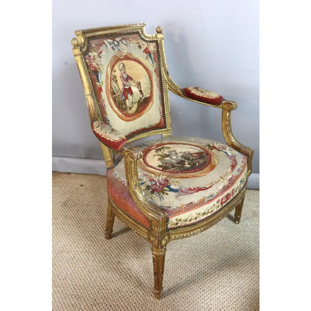 Pair of 19th-century Louis XVI giltwood armchairs covered with beautiful tapestry in fairly good condition with some wear....