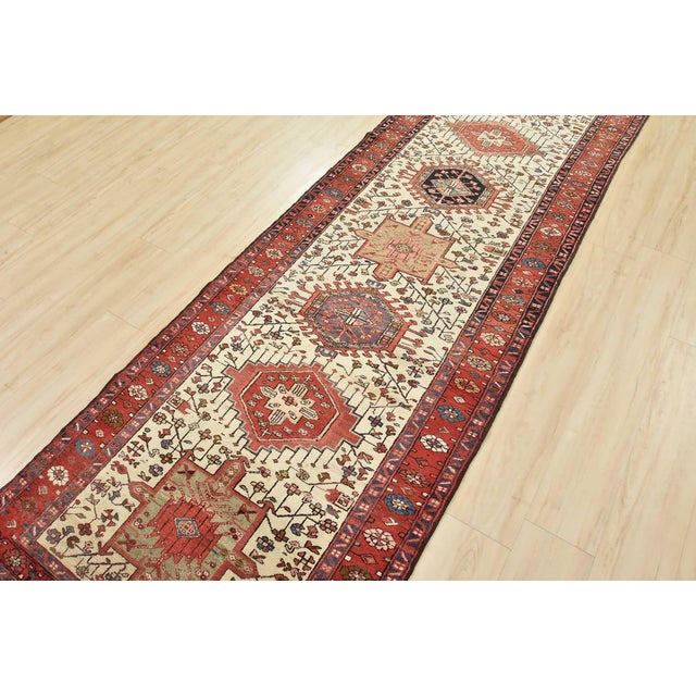 This authentic semi-antique tribal Karajeh runner is hand-knotted with fine wool and natural dyes. This oriental rug...