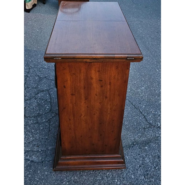 A gorgeous Drexel Brass Mount Fruitwood Fold-Top Mini Bar with double French Doors. Very good vintage condition. Measures...