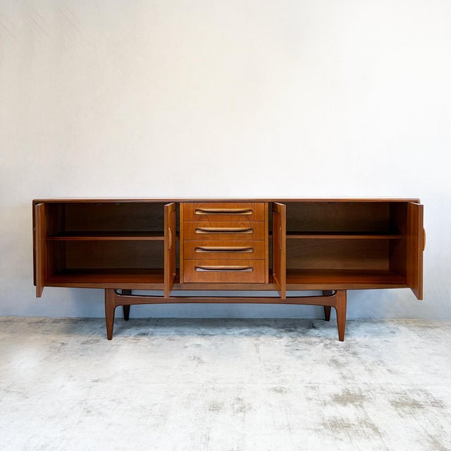 A large sideboard designed by Victor Bramwell Wilkins for G-Plan as part of the Fresco range. Teak veneer construction...