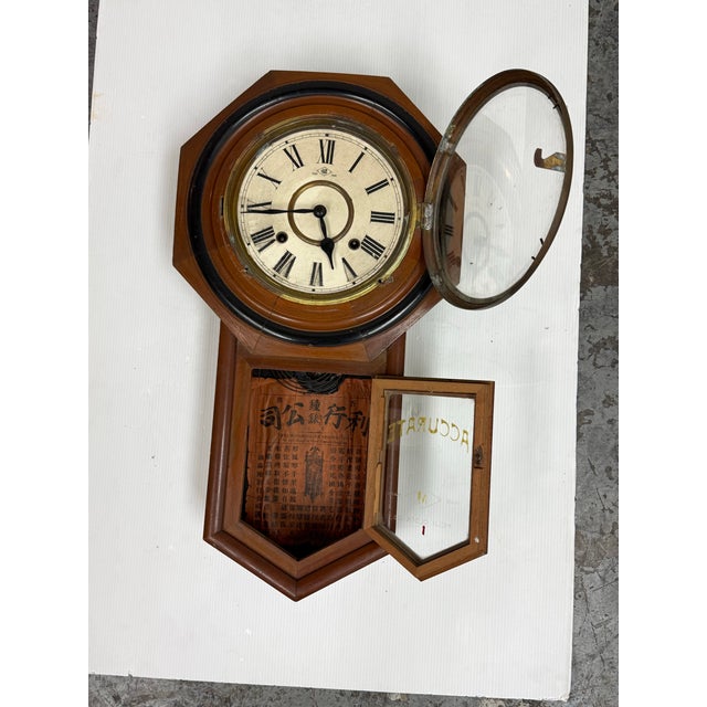 Design Plus Gallery presents an Antique Meiji Clock Co. Octagonal Pendulum Wall Clock. The wood case has an octagonal...