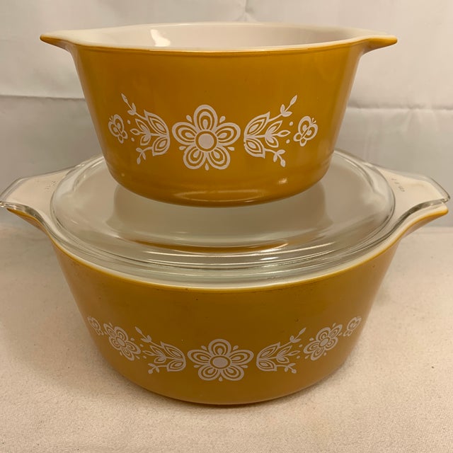 This set features the vintage Pyrex Butterfly Gold pattern, introduced by Corning in 1972, showcasing a cheerful yellow-...