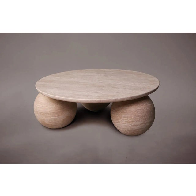 Expertly carved and hand-finished from solid blocks of vein-cut travertine, each piece exhibits the inherent variations in...