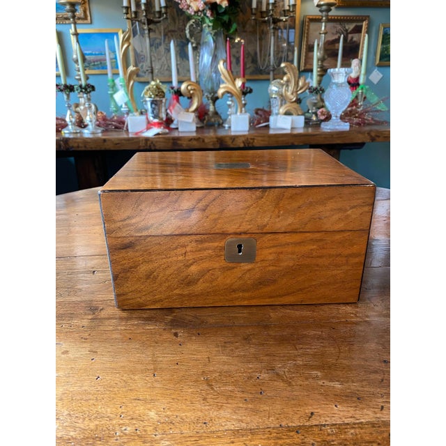 A 19th century mahogany sewing box with red silk interior ad multiple compartments. From England, 19th century.