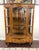 This vintage bowfront curio china cabinet features richly figured burled walnut veneers, a gracefully curved glass door,...