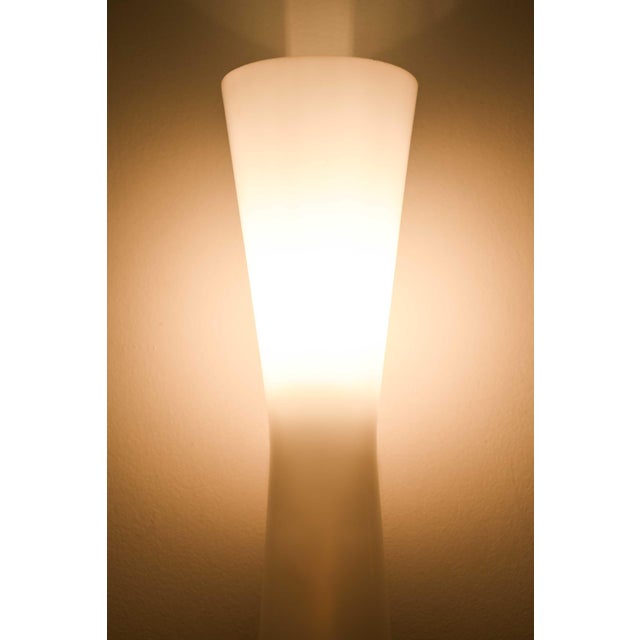 This elegant pair of mid-century modern wall lamps, produced in sweden by an unknown designer, reflects the understated...