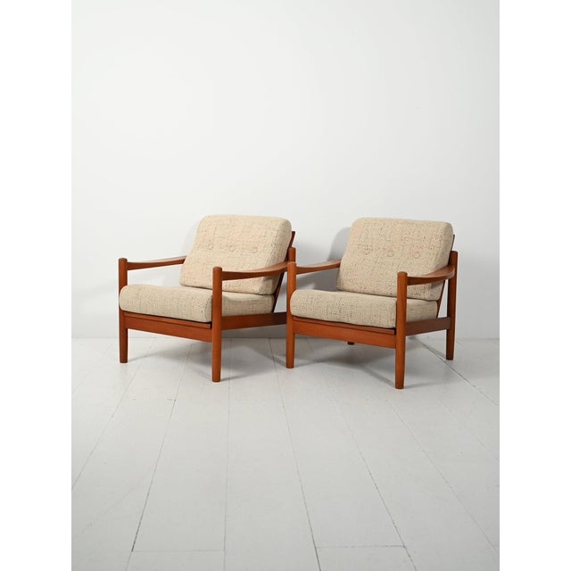 Pair of 1950s Danish teak armchairs, sculpted armrests, and removable cushion covers in beige melange fabric. Probably...