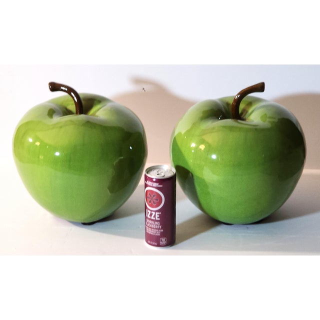 These monumentally large ceramic decorative apples make a whimsical pop art statement in a kitchen or dining room setting....