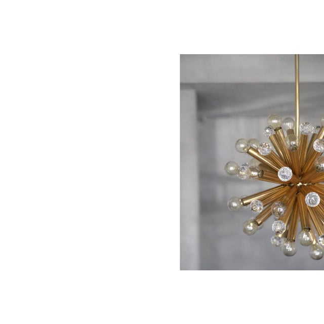 This stunning chandelier was manufactured by Ernst Palme in German Westheim during the 1960s. This lamp has a gilt brass...