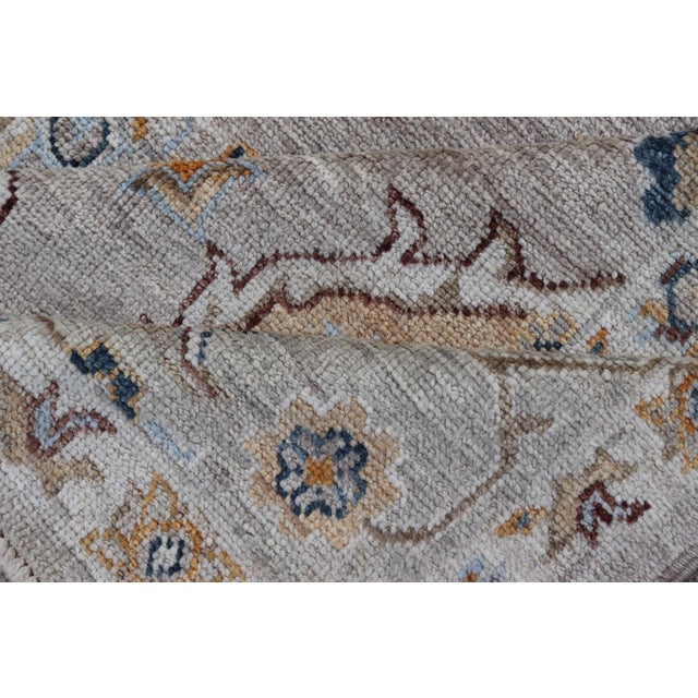 Turkish Angora Oushak Rug With Light Gray Field and Warm Earth Tone Accents For Sale - Image 16 of 17