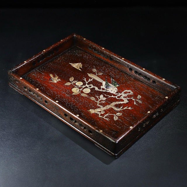 This is a beautifully crafted rectangular wooden tray featuring intricate mother-of-pearl (nacre) inlay work. Crafted from...