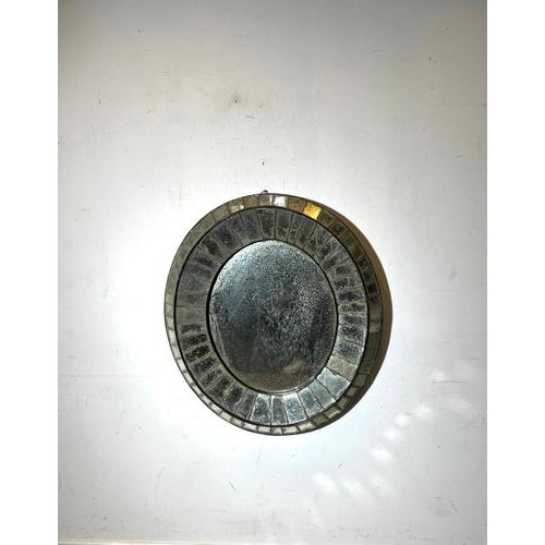 Beautiful vintage Venetian style mirror featuring a decorative frame composed of faceted mirror segments surrounding a...