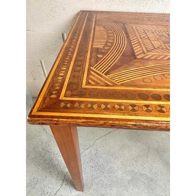 A charming and finely crafted game table featuring an intricately hand-laid parquetry top decorated with playing card suit...