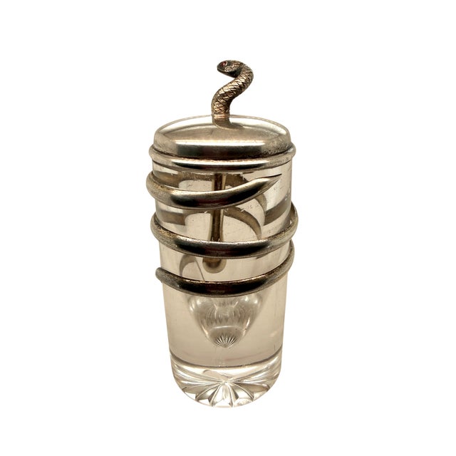 A striking Tiffany & Co. Art Nouveau perfume bottle dating to 1891–1902, featuring a sculptural sterling silver snake...