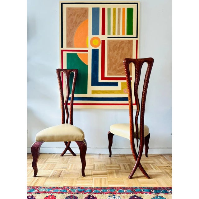 Superbly stylized pair of Christopher Guy chairs whimsical extremely high backs with a double curved edge hand-carved from...