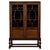 A handsome early 20th-century English display cabinet, finely crafted from oak and distinguished by its elegant glazed...