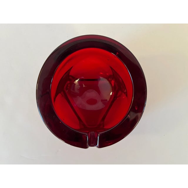 A vintage Viking Art Glass Mid Century Modern mold-blown ruby glass ashtray or dish, 1970s. An elegant abstract geometric...
