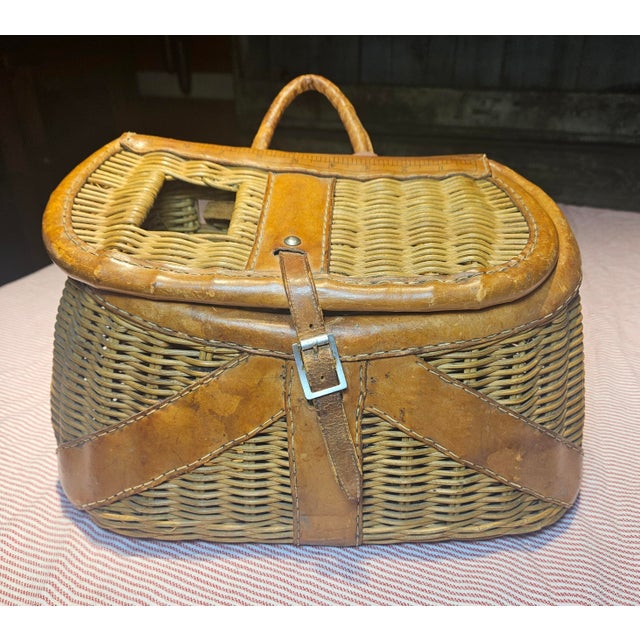 This vintage wicker fishing creel was once a trusty companion for anglers, keeping their catch cool and fresh by dampening...
