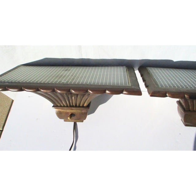 Matching pair of bronze Chapman uplight sconces from 1979. Cast bronze frames with metal grill insert tops. Now fitted...