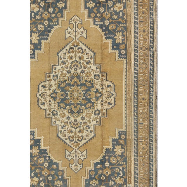Measures: 6'10'' x 11'5'' Characterized by a comely and highly representative Oushak composition, this vintage carpet...