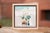 This artwork depicts a serene urban scene, characterized by soft, muted colors and an impressionistic approach to form....