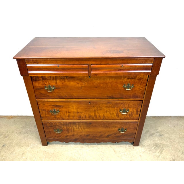 An impressive late Federal early Empire 19th century cherry wood chest of drawers with brass drawer pulls and detailed...
